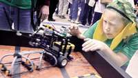 Samantha Jones, 9, of the Mars Pets team from Wilkins Elementary School in Amherst, lines up her teams robot for a test run during the FIRST Lego League state tournament Dec. 13 at the north campus of Nashua High School.