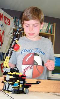 Ryan Simard works on his FIRST LEGO League team's robot Monday before heading to the FLL World Festival in Atlanta.  The Milford-based team is the only LEGO team representing New Hampshire.
